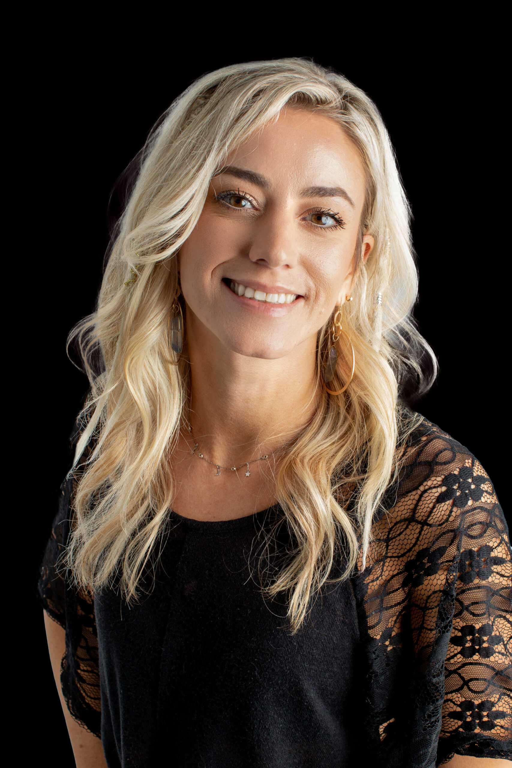 Portrait of Corinne, a professional stylist at Fusion Salon Avalon, showcasing their expertise and style.