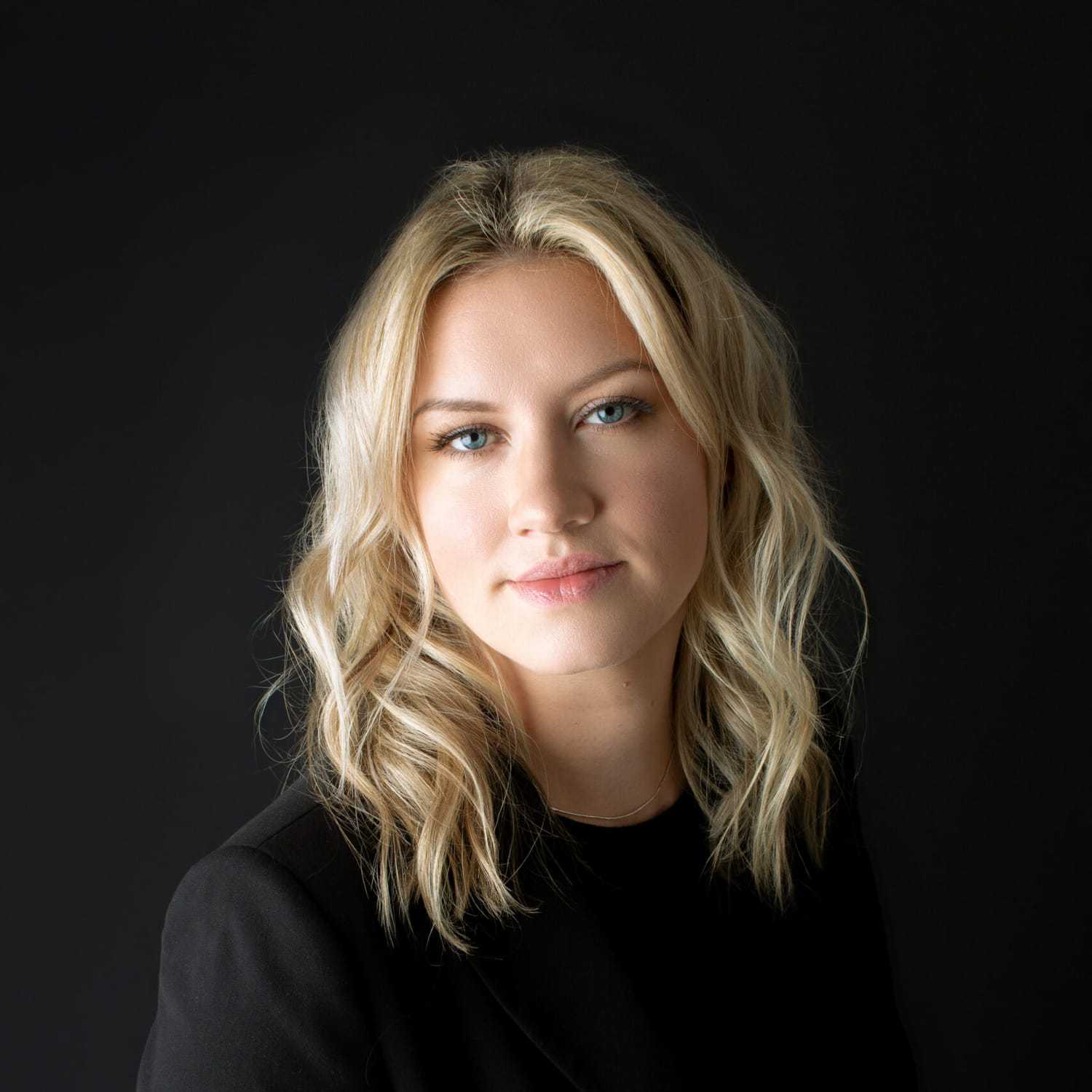 Portrait of Courtney, a professional stylist at Fusion Salon Avalon, showcasing their expertise and style.