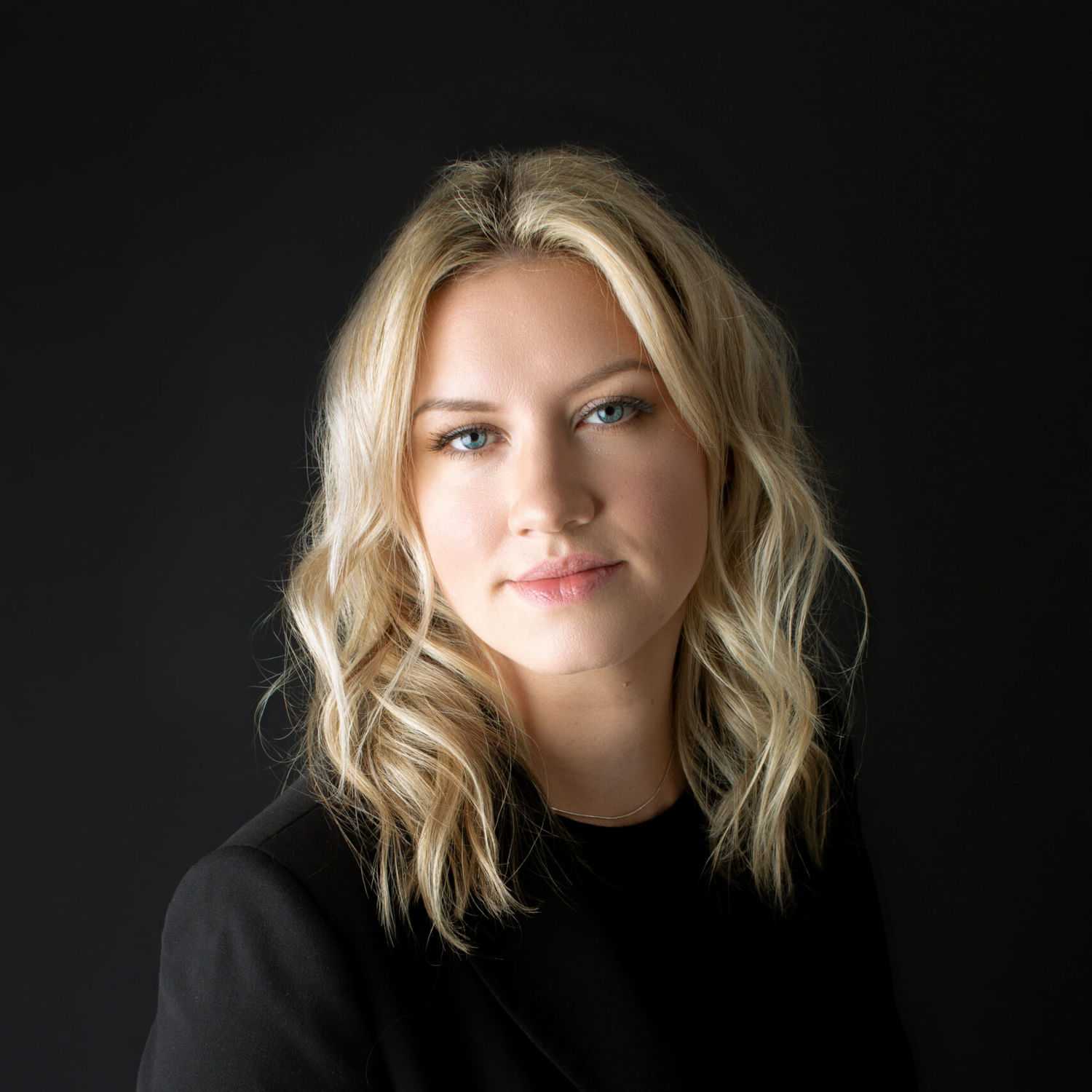 Portrait of Courtney, a professional stylist at Fusion Salon Avalon, showcasing their expertise and style.