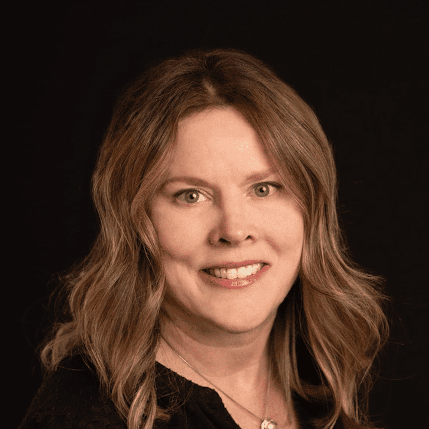 Portrait of Jackie, a professional stylist at Fusion Salon Avalon, showcasing their expertise and style.