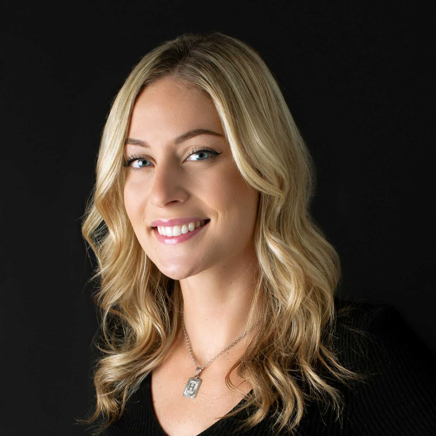 Portrait of Haley, a professional stylist at Fusion Salon Avalon, showcasing their expertise and style.