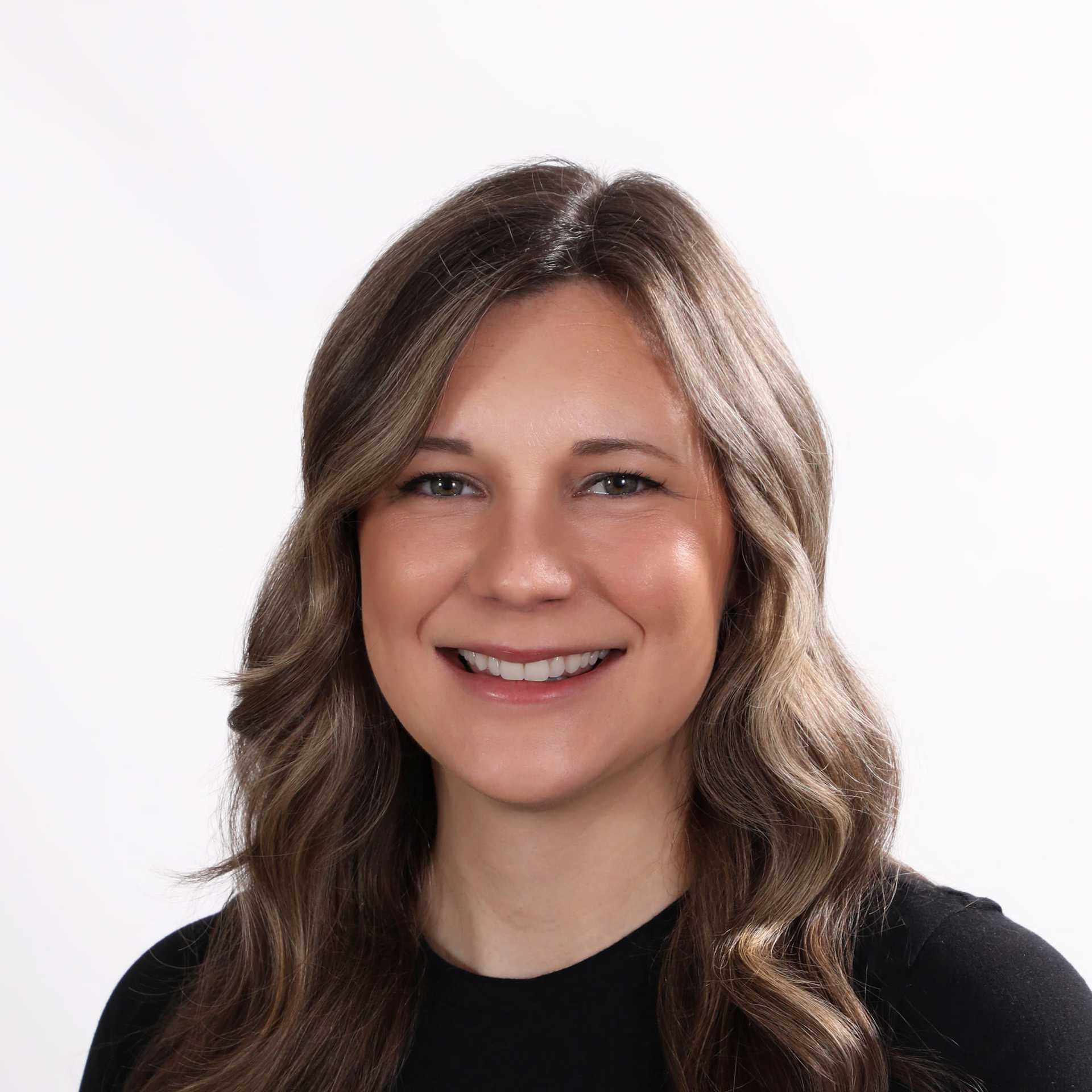Portrait of Caitlin, a professional stylist at Fusion Salon Avalon, showcasing their expertise and style.